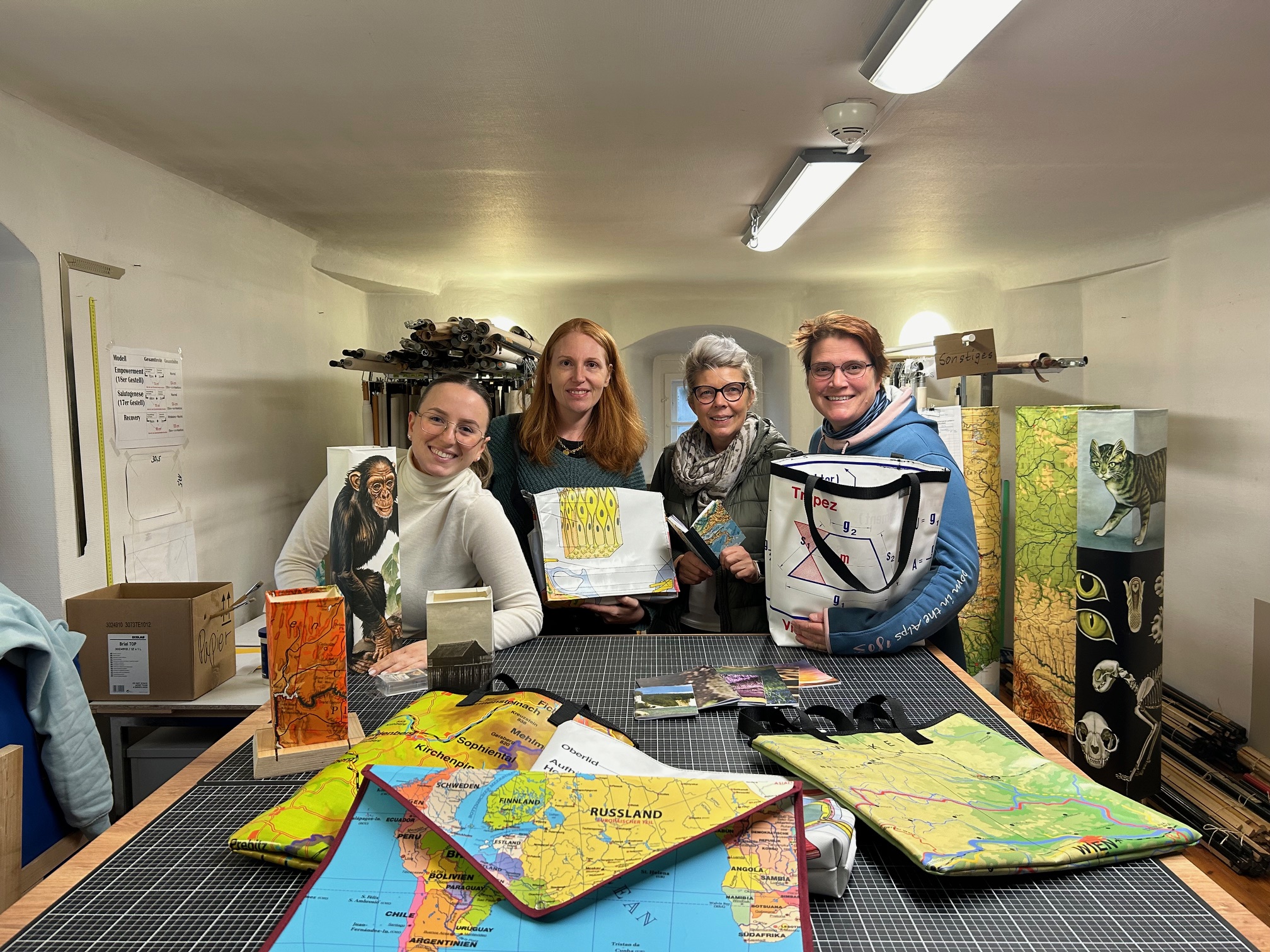 Das Team der Tagesstätte für seelische Gesundheit Günzburg zeigt, was man alles aus den alten Schulkarten machen kann: (von links) Edona Haxha, Corinna Farin, Ilona Brand und Leiterin Christine Bayerle. Bild: Lisa Müller, Bezirkskliniken Schwaben