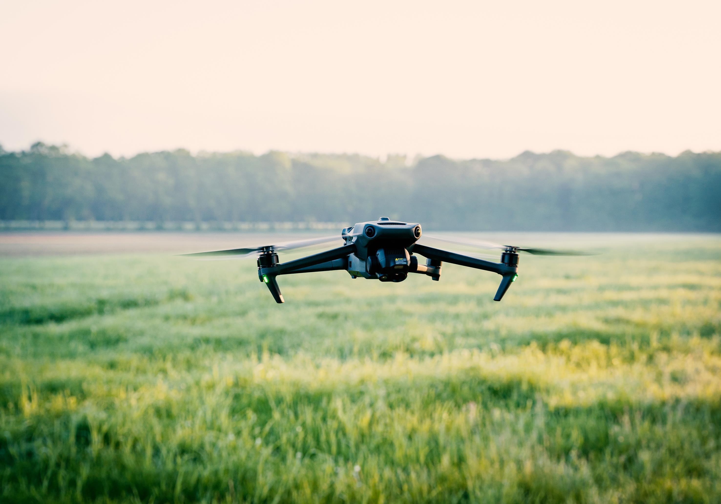 Drohne fliegt über landwirtschaftlicher Wiese